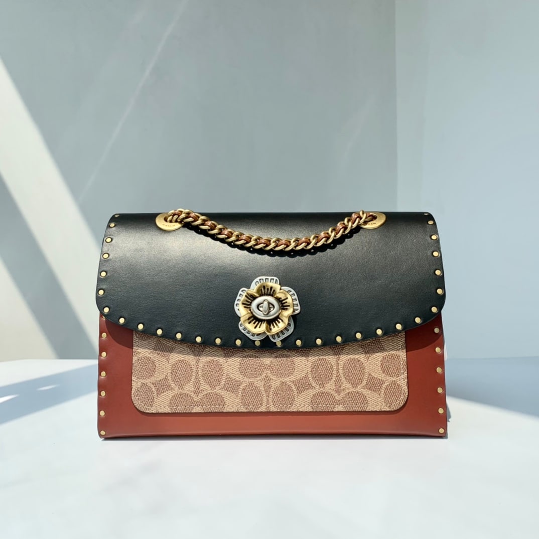 COACH MADISON: The COACH iconic canvas with studs and snakeskin details, paired with the MADISON classic shoulder bag, combines timeless style with modern design, making it suitable for various occasions such as