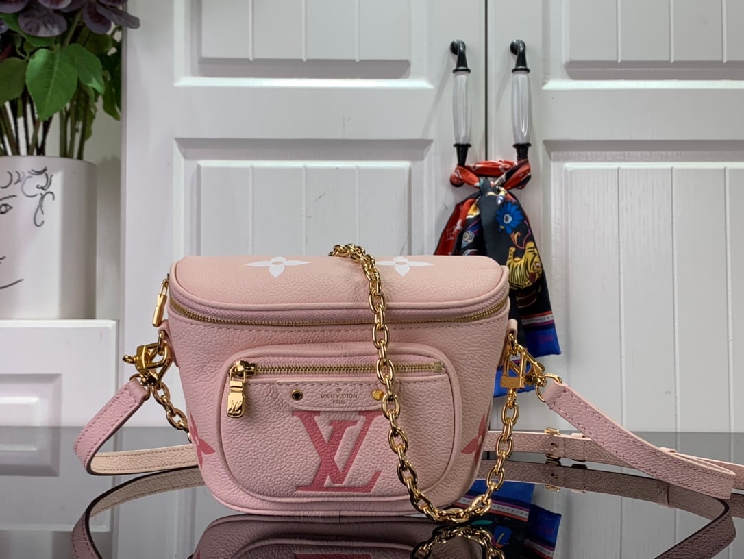 LV MINI BUMBAG: The Mini Bumbag, from the LV Gradient collection, is crafted from Monogram Empreinte leather with a Monogram embossed pattern and gradient summer colors. Its trendy design features a zippered main com