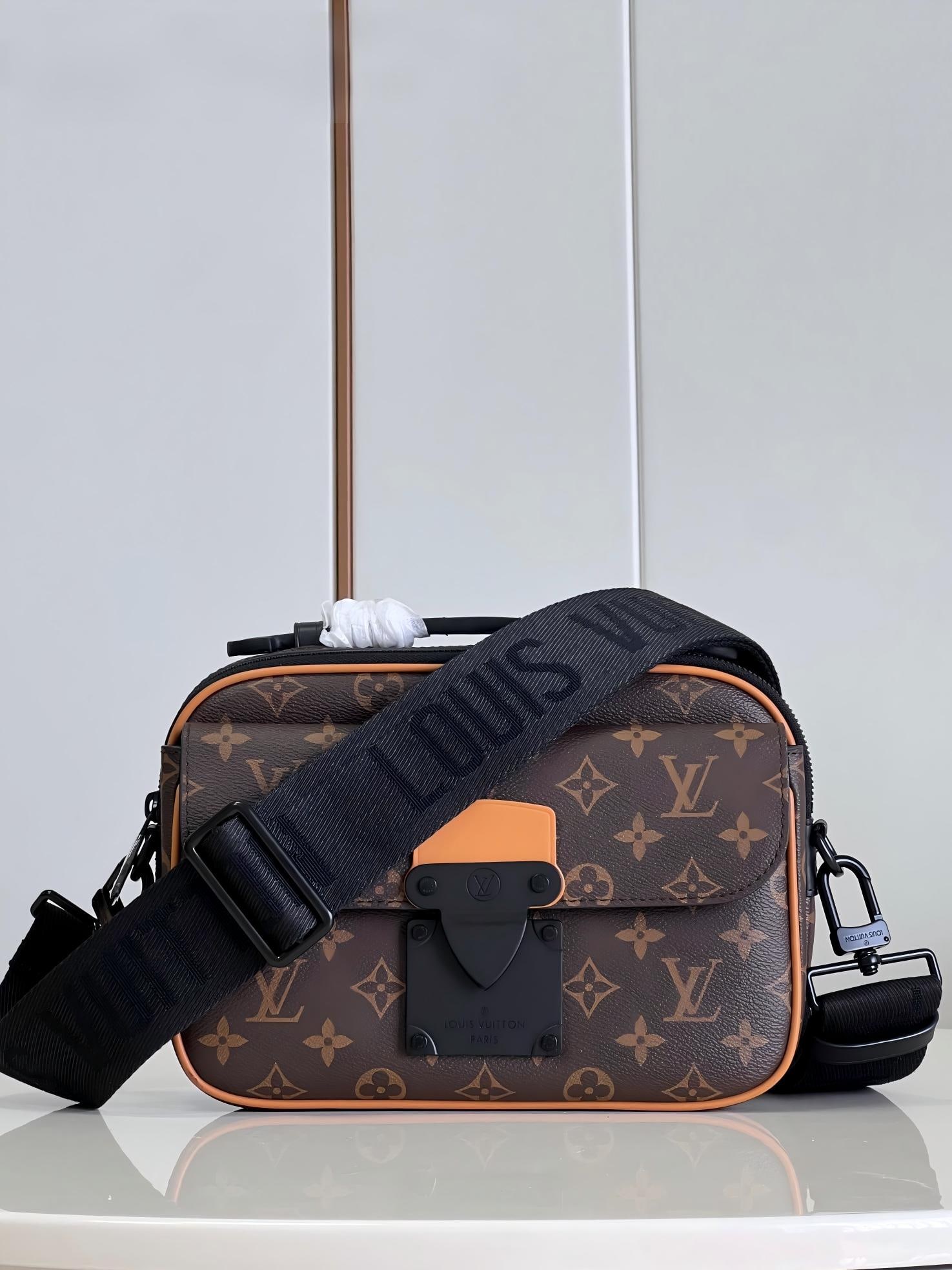 LV S Lock messenger bag: The S Lock messenger bag is crafted from Monogram Macassar canvas, featuring a lock inspired by the trunk lock designed by Georges Vuitton in 1886. A special finishing process gives this magnetic meta