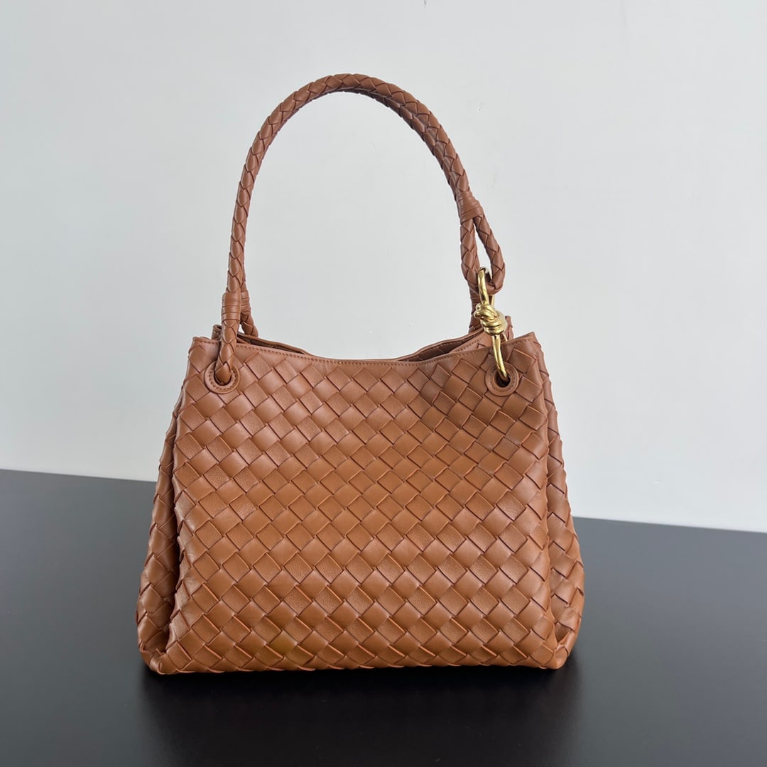 Bottega Veneta intrecciato: The Bottega Veneta intrecciato woven leather shoulder bag features a detachable shoulder strap, a built-in mini pouch, and retains Bottega Veneta's unique woven design. This parachute bag is so appeal