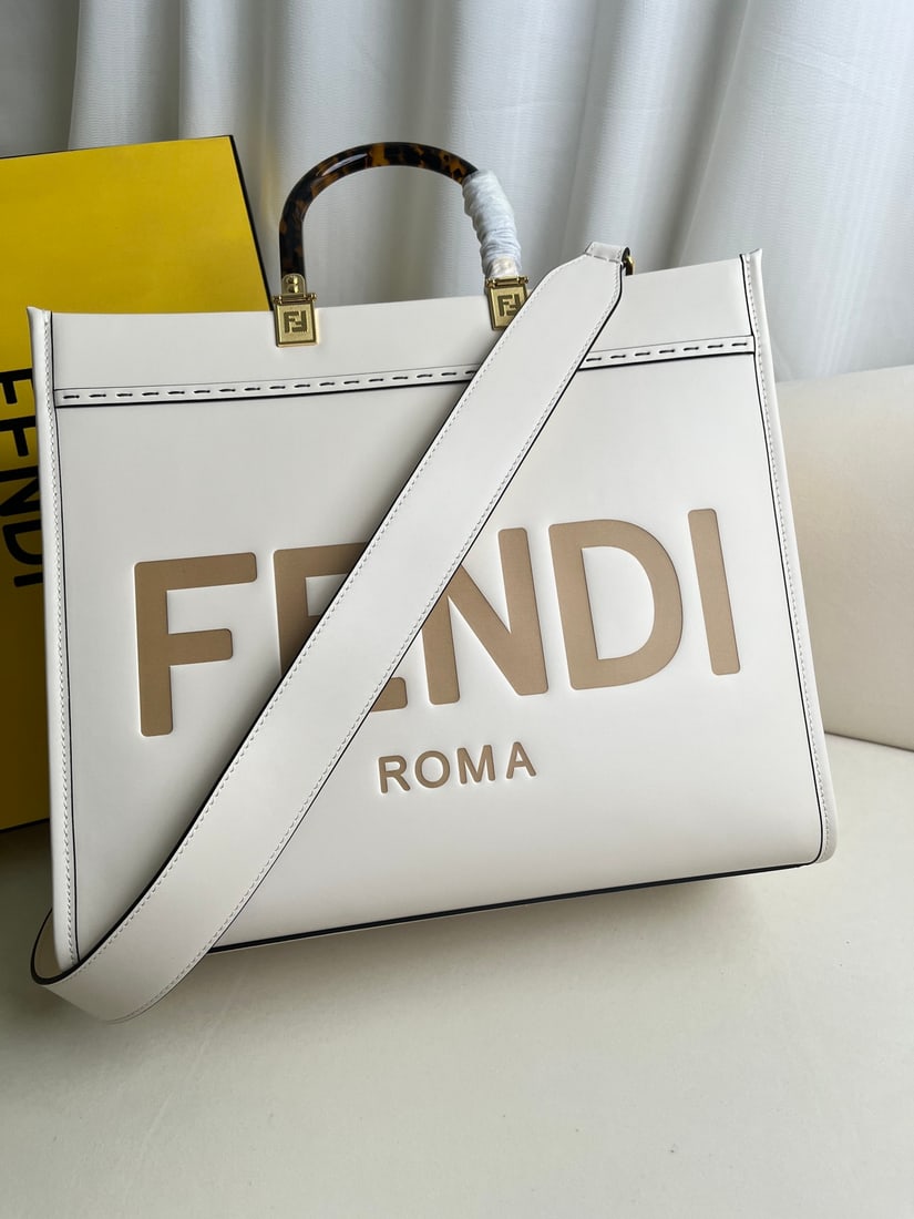 Fendi Sunshine: White Fendi Medium Sunshine Shopping Tote Bag, also in brown leather, adorned with embossed FENDI ROMA lettering and hard DAIMAO-effect acrylic handles. Features a spacious, lined interior compartment