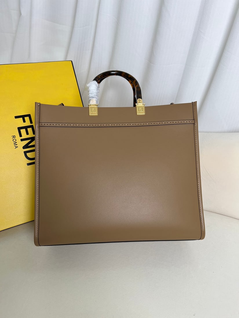 Fendi Sunshine: Apricot Fendi Medium Sunshine Shopping Tote Bag, also in brown leather, adorned with embossed FENDI ROMA lettering and hard DAIMAO-effect acrylic handles. Features a spacious, lined interior compartme