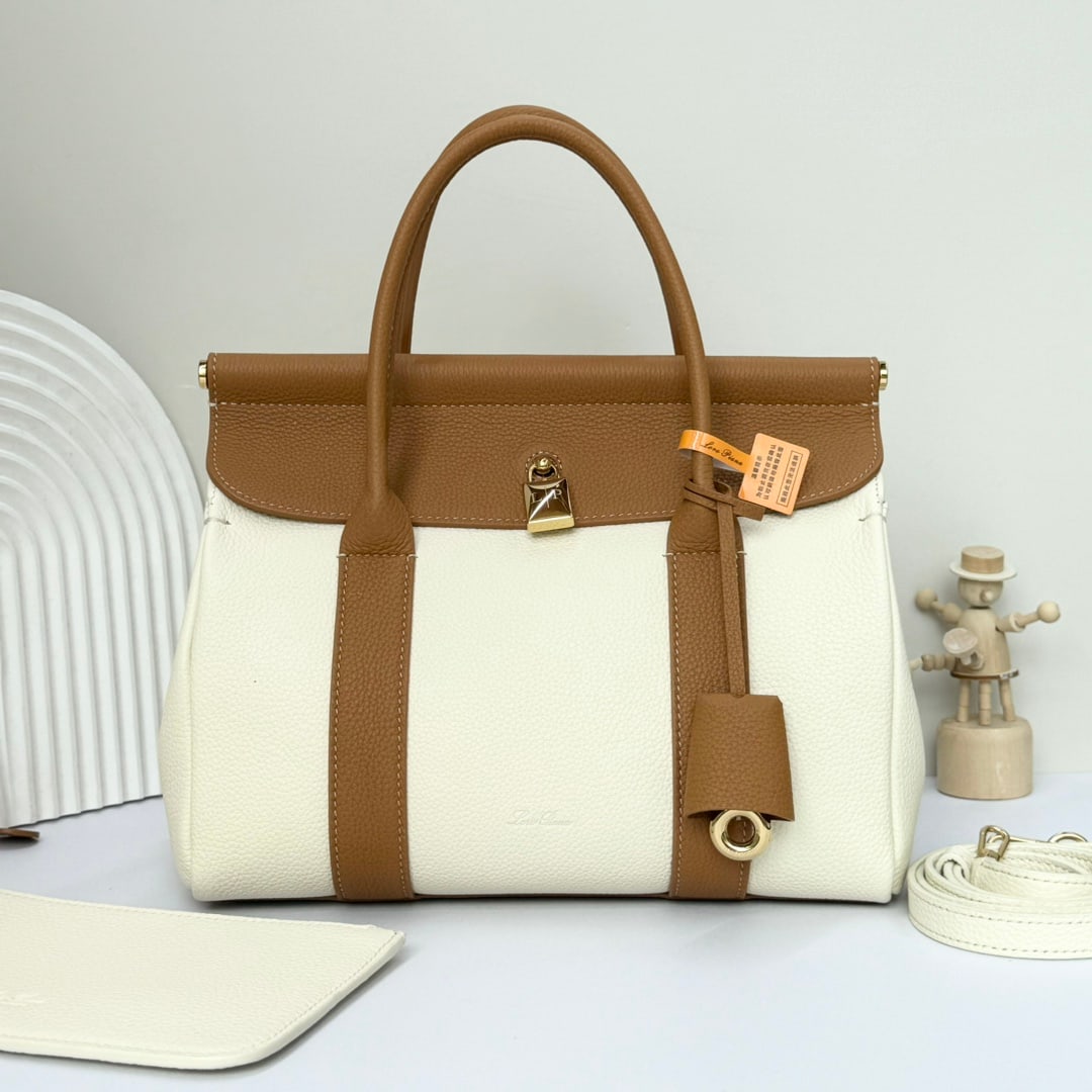 Loro piana Loro piana Loom L25 Handbag: The Loro Piana Loom L25 tote bag is crafted from premium calfskin with a suede lining, offering a unique and lightweight feel. It features a delicate padlock that can be opened, exuding a casual style