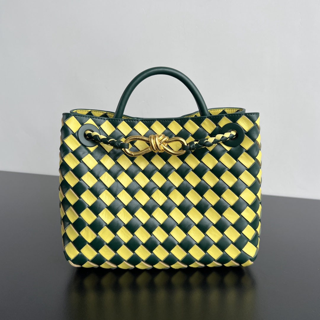 Bottega Veneta: The Bottega Veneta Andiamo handbag, a limited edition for the Year of the Dragon, features a playful two tone checkered woven pattern paired with a gold rope knot clasp, making it exceptionally eye