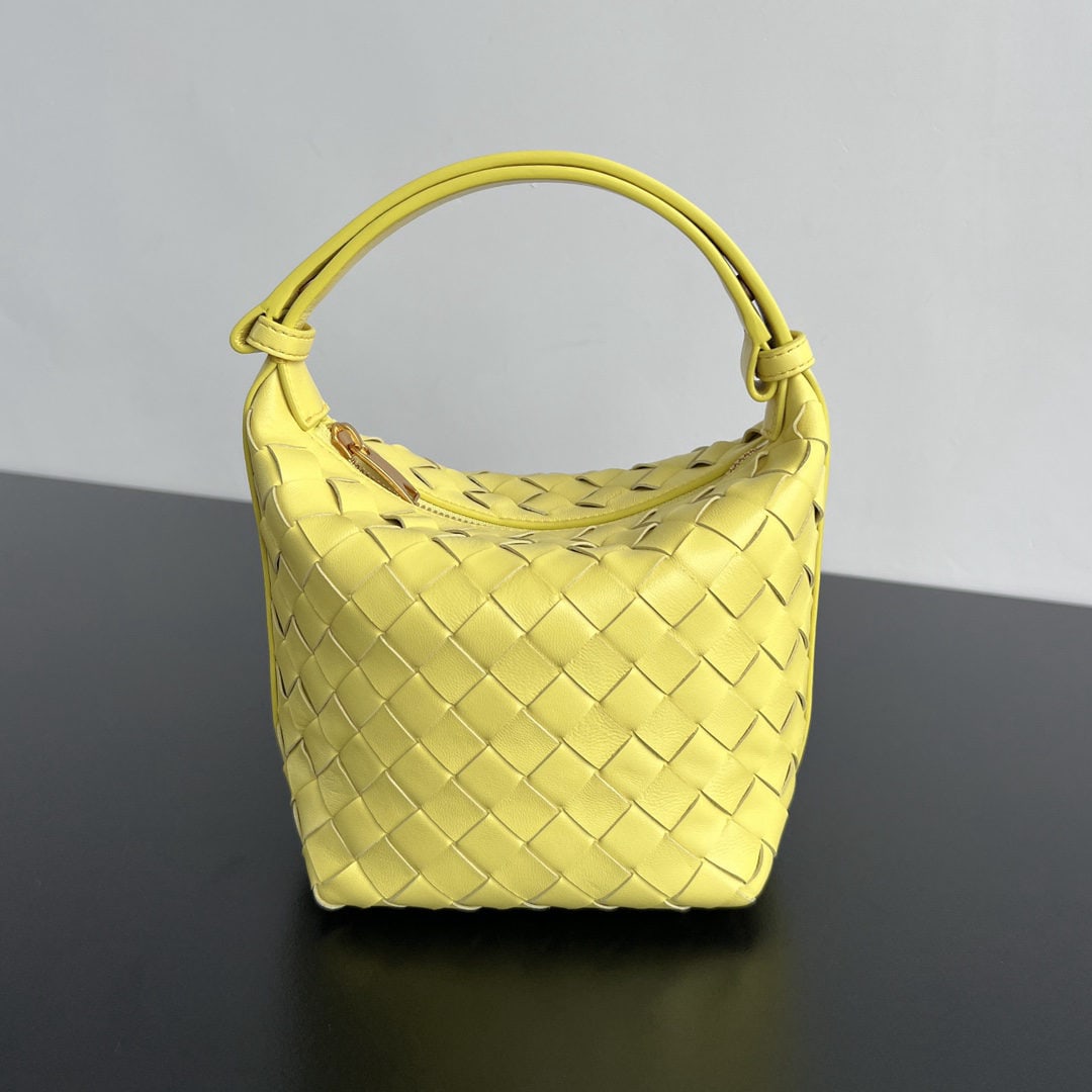 Bottega Veneta: The Bottega Veneta Wallace shoulder bag is a convenient lunchbox bag that you can easily carry around. It features the classic intrecciato weaving technique, showcasing Bottega's craftsmanship. The