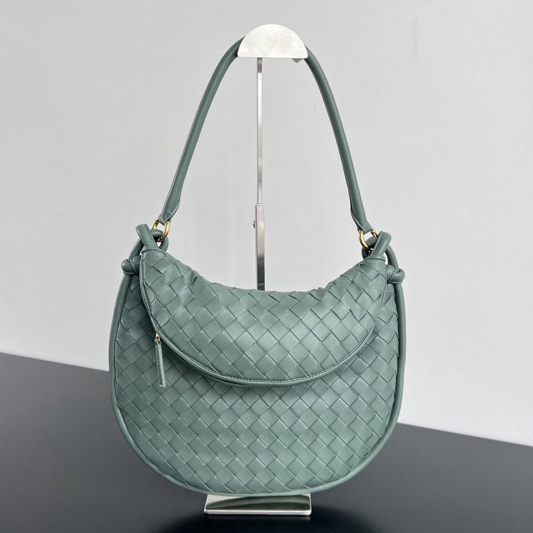 Bottega Veneta: The Bottega Veneta Gemelli twin bag is a pair of two half moon shaped bags from the Gemelli series, crafted from the brand??s signature intrecciato woven lambskin. It features detachable tubular