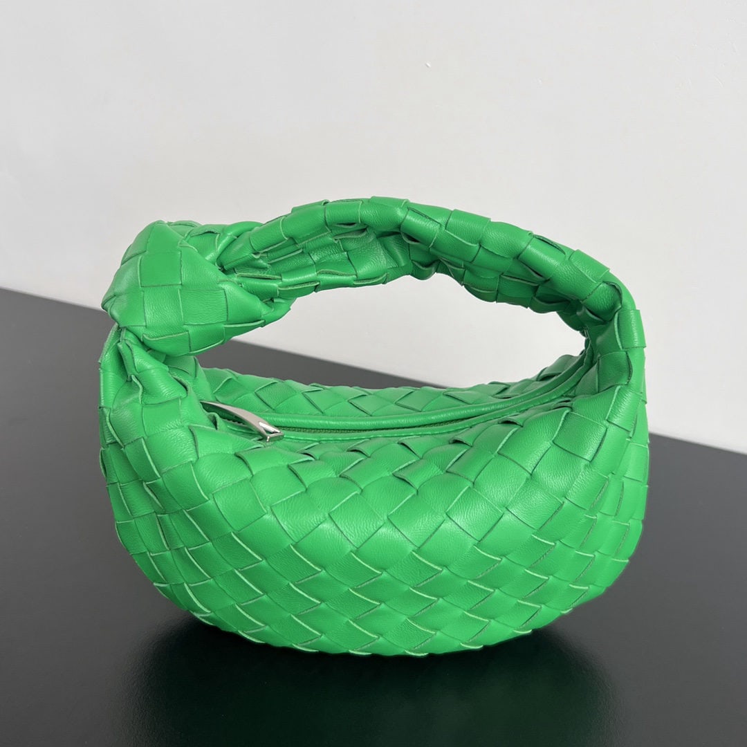 Bottega Veneta: Bottega Veneta's 2021 Early Spring Collection Mini Jodie bag features rounded corners, a classic woven leather knotted round hobo bag, and the iconic triangular zipper design. Made of soft, draping