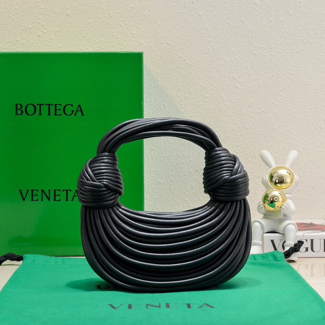 Bottega Veneta: The Bottega Veneta Jodie Ramen clutch bag features a unique and playful design inspired by the designer. Made inside and out from imported lambskin, its supple shape, adorned with a novel knot