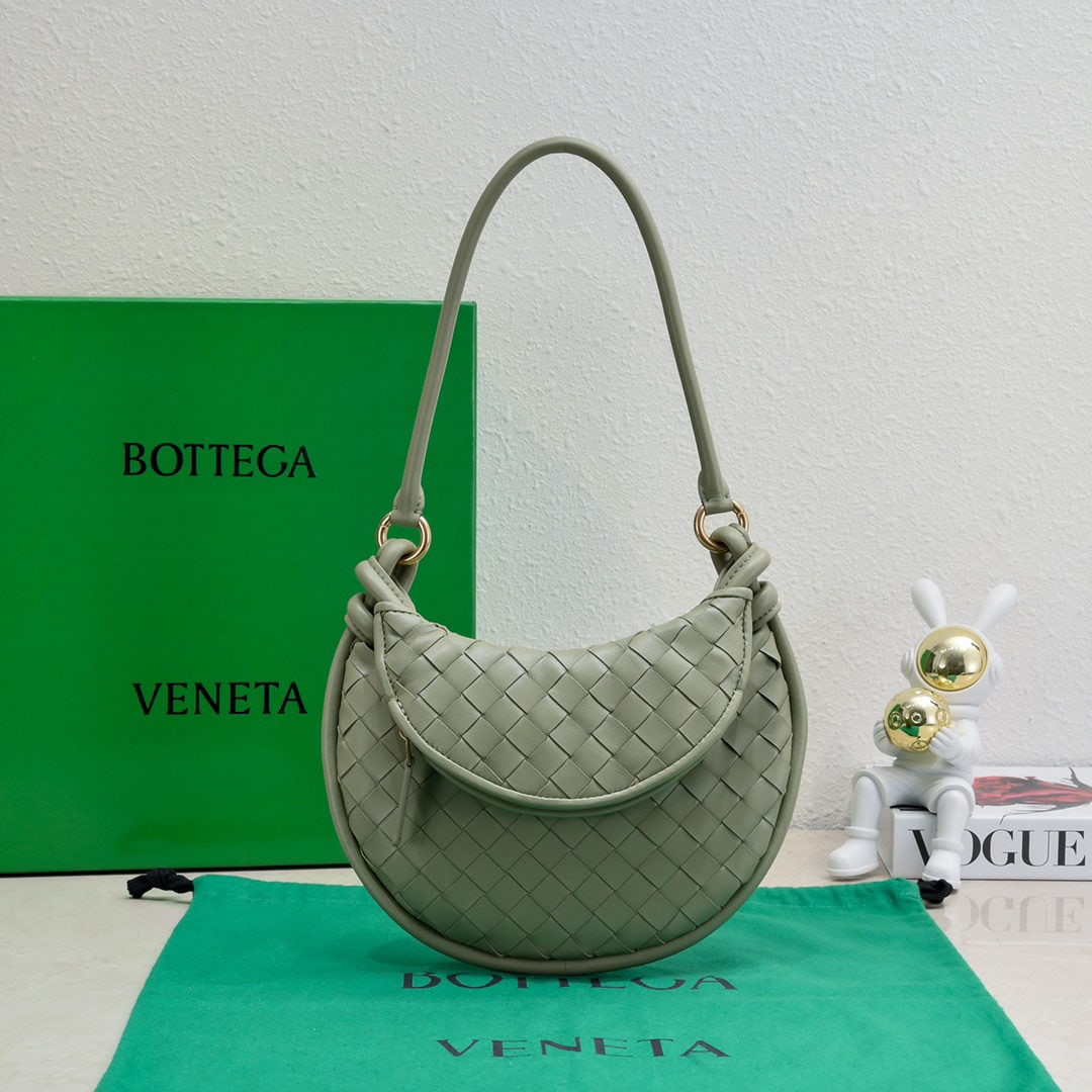 Bottega Veneta: The Bottega Veneta Gemelli twin bag is a pair of two half moon shaped bags from the Gemelli series, crafted from the brand??s signature intrecciato woven lambskin. It features detachable tubular