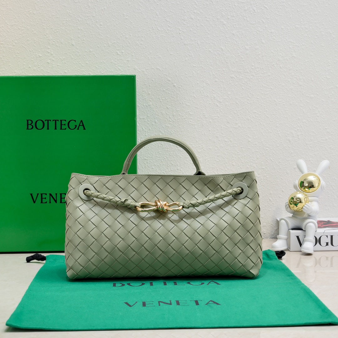 Bottega Veneta: The Bottega Veneta Andiamo horizontal handbag, a favorite among many celebrities, features a classic all over leather woven design with a gold rope knot clasp, exuding both sophistication and