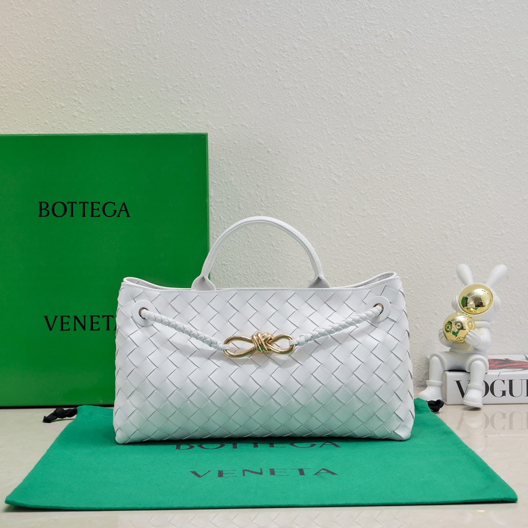 Bottega Veneta: The Bottega Veneta Andiamo horizontal handbag, a favorite among many celebrities, features a classic all over leather woven design with a gold rope knot clasp, exuding both sophistication and elegance