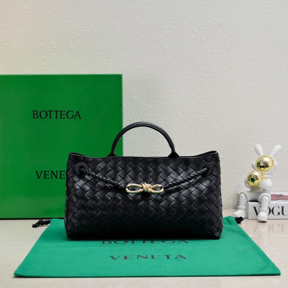 Bottega Veneta: The Bottega Veneta Andiamo horizontal handbag, a favorite among many celebrities, features a classic all over leather woven design with a gold rope knot clasp, exuding both sophistication and