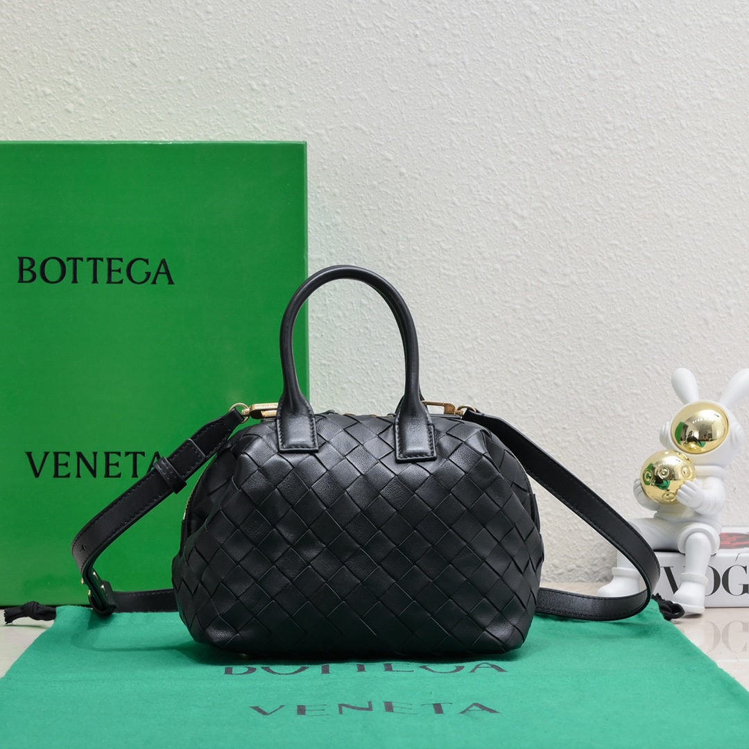 Bottega Veneta: The Bottega Veneta Small Intrecciato woven leather bowling bag features a detachable crossbody strap, a single interior flat pocket, and a zip closure. The classic woven craftsmanship is an