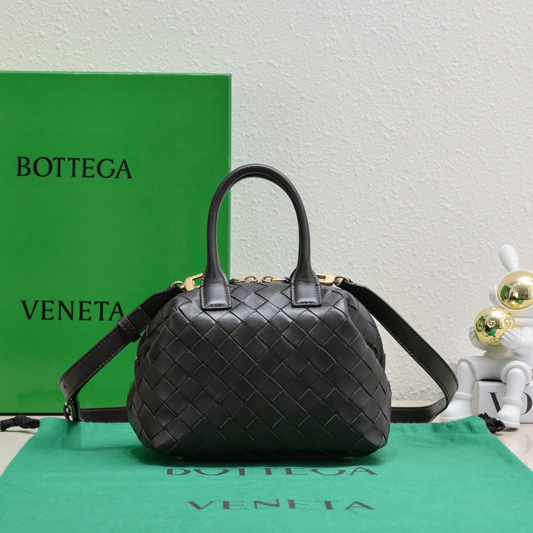 Bottega Veneta: The Bottega Veneta Small Intrecciato woven leather bowling bag features a detachable crossbody strap, a single interior flat pocket, and a zip closure. The classic woven craftsmanship is an indispensa
