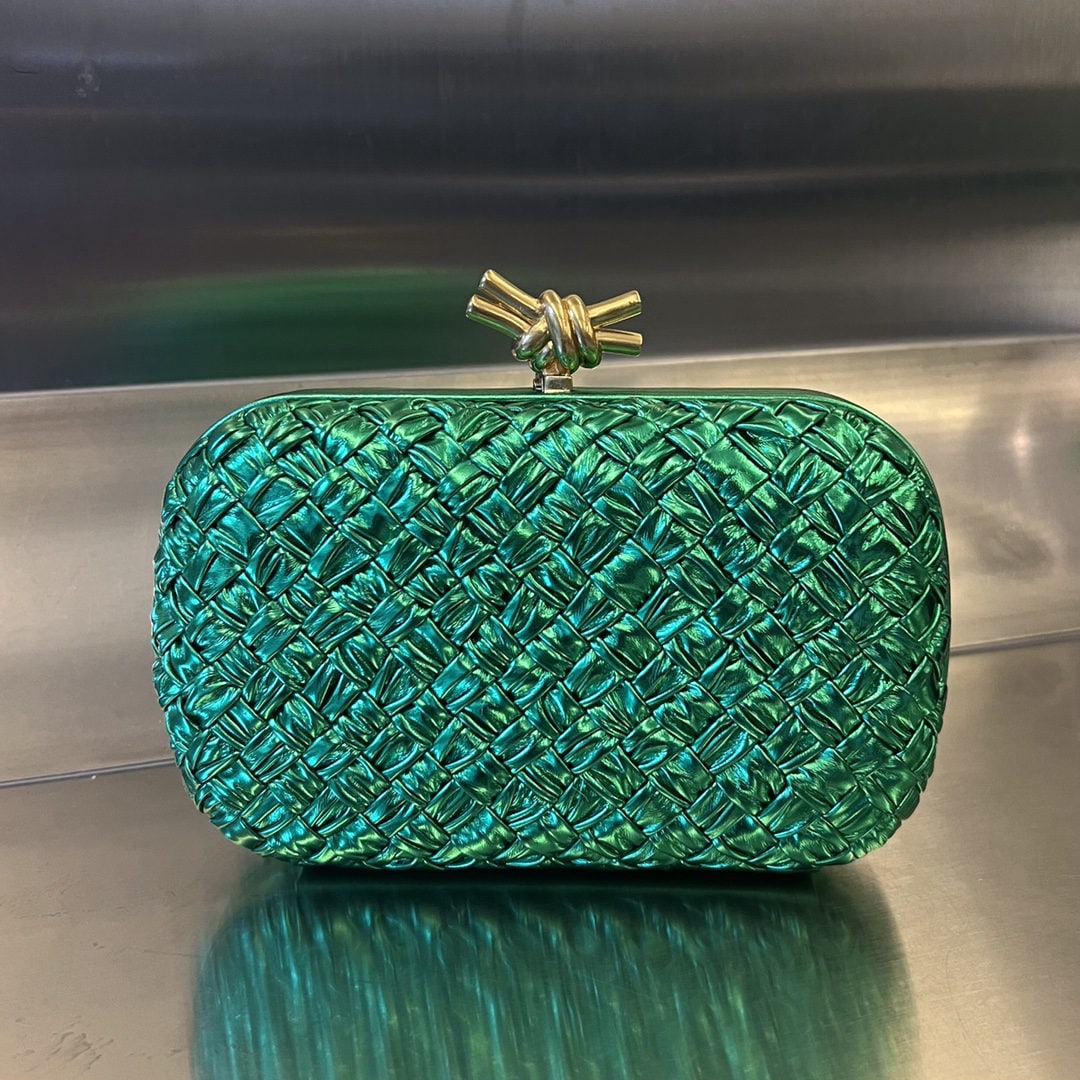 Bottega Veneta: The Bottega Veneta Knot evening clutch features the iconic woven texture and a metal knot clasp, exuding elegance and sophistication. The soft, comfortable lambskin leather and knotted metal accents