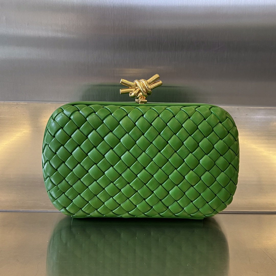 Bottega Veneta: The Bottega Veneta Knot evening clutch features the iconic woven texture and a metal knot clasp, exuding elegance and sophistication. The soft, comfortable lambskin leather and knotted metal accents c