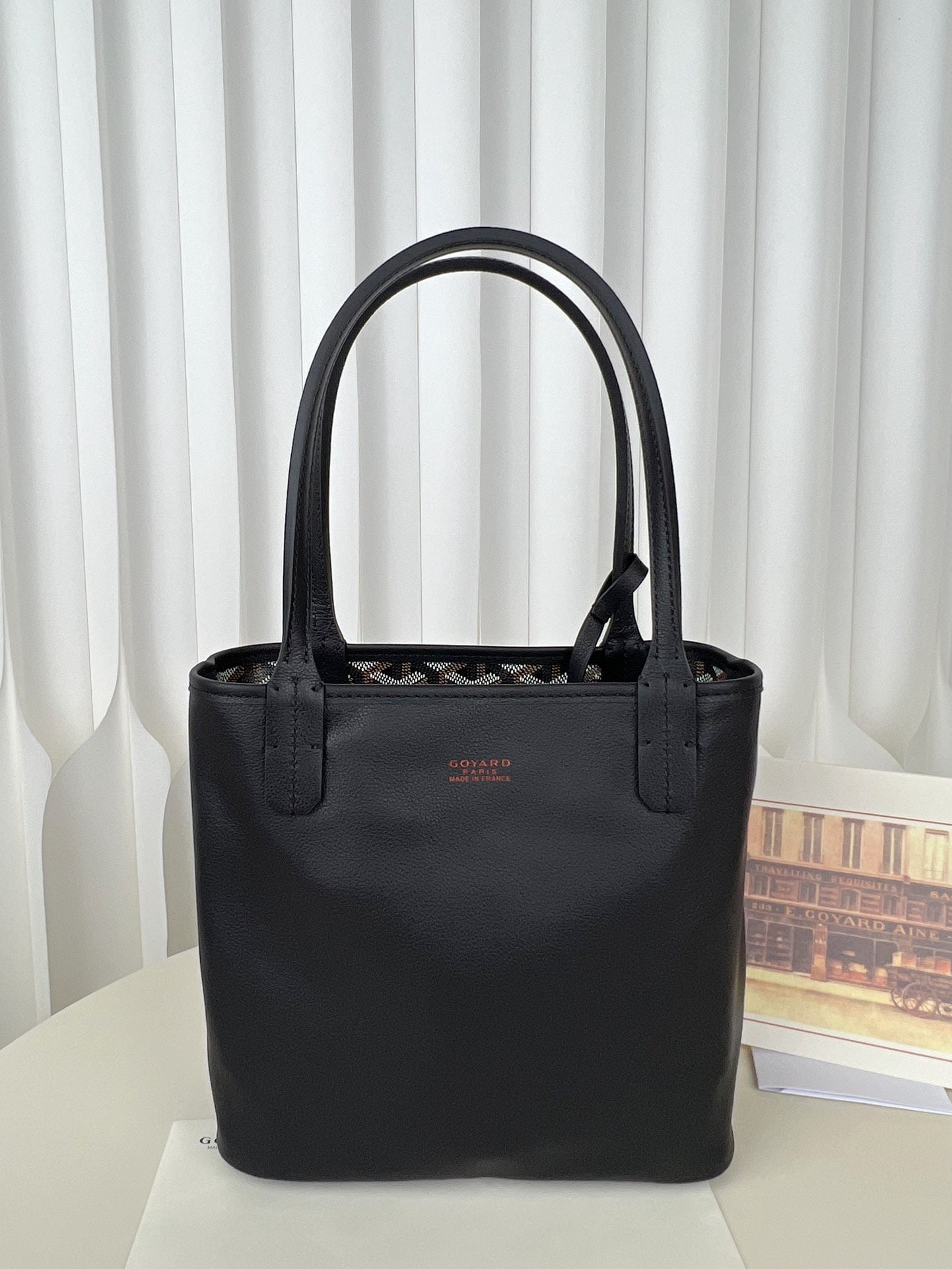 Goyard Tote Mini Anjou: The Goyard TOTE MINI ANJOU is a low key yet stylish reversible mini tote bag crafted from Italian calfskin. The leather is incredibly soft and supple to the touch. The monogram print paired with solid