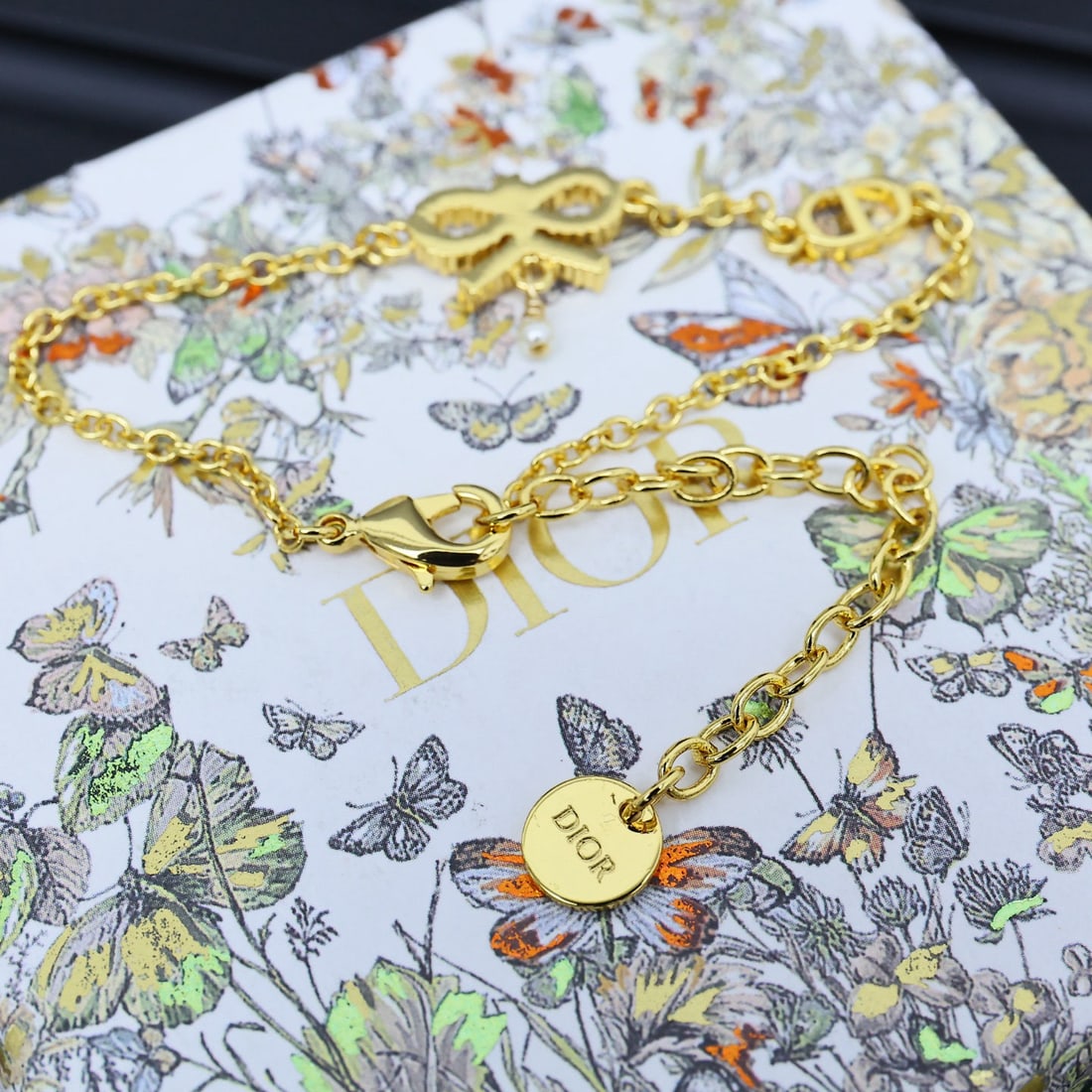 Dior bow bracelet: Dior bow bracelet. Dior designers understand romance. This accessory sparkles in the sunlight, its rhinestones adding a touch of luxury to any outfit. Each rhinestone is exquisitely cut, refracting de