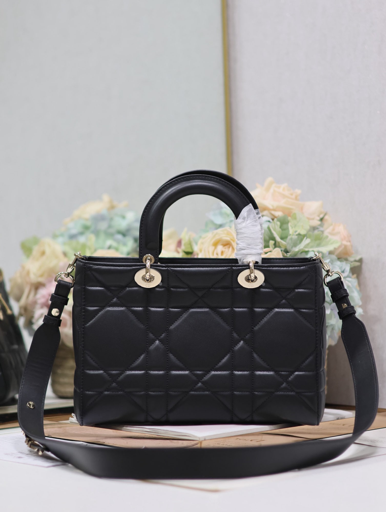 Christian Dior Lady Dior: The medium sized black Lady D Sire My ABC Dior handbag, crafted from black plain calfskin, made a stunning debut at the Dior Spring/Summer 2024 ready to wear collection, drawing inspiration from the c