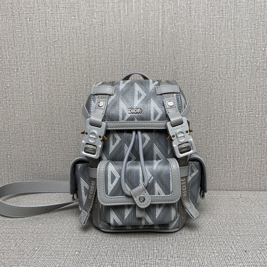 Christian Dior Hit the Road: The Dior Hit the Road Mini Backpack, part of the Spring 2024 Menswear collection, blends modern style with Dior's haute couture spirit. Crafted from Dior grey CD Diamond patterned canvas, it draws ins