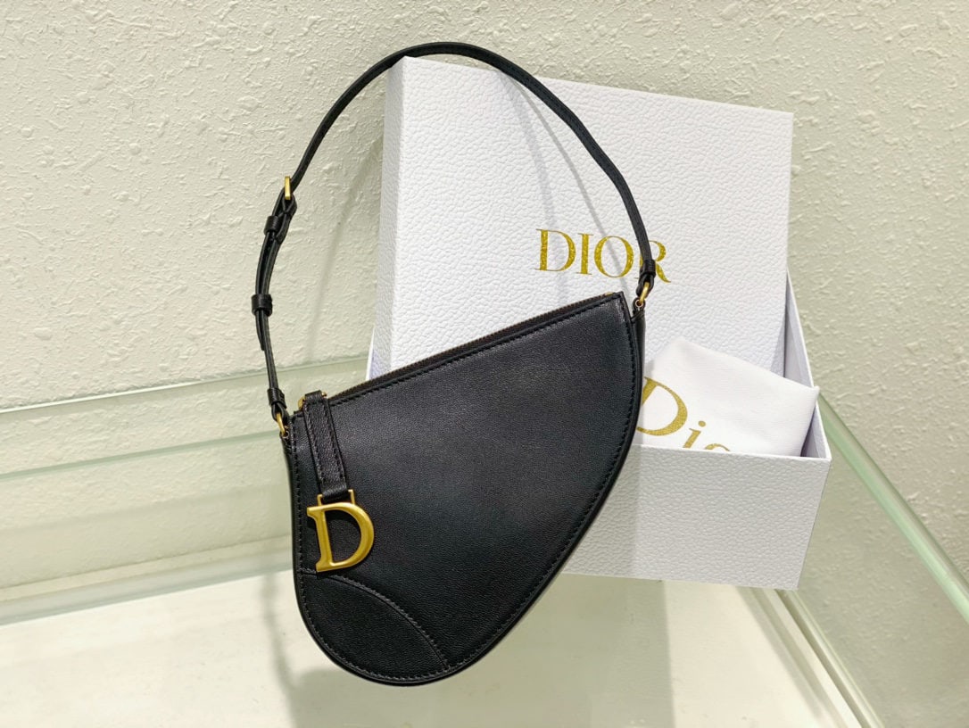 Christian Dior Saddle Bag: The Dior Saddle Bag clutch is part of the 2024 Early Spring/Summer collection, reinterpreting classic elements of the namesake collection, such as the vintage gold plated metal stirrup D shaped charm.