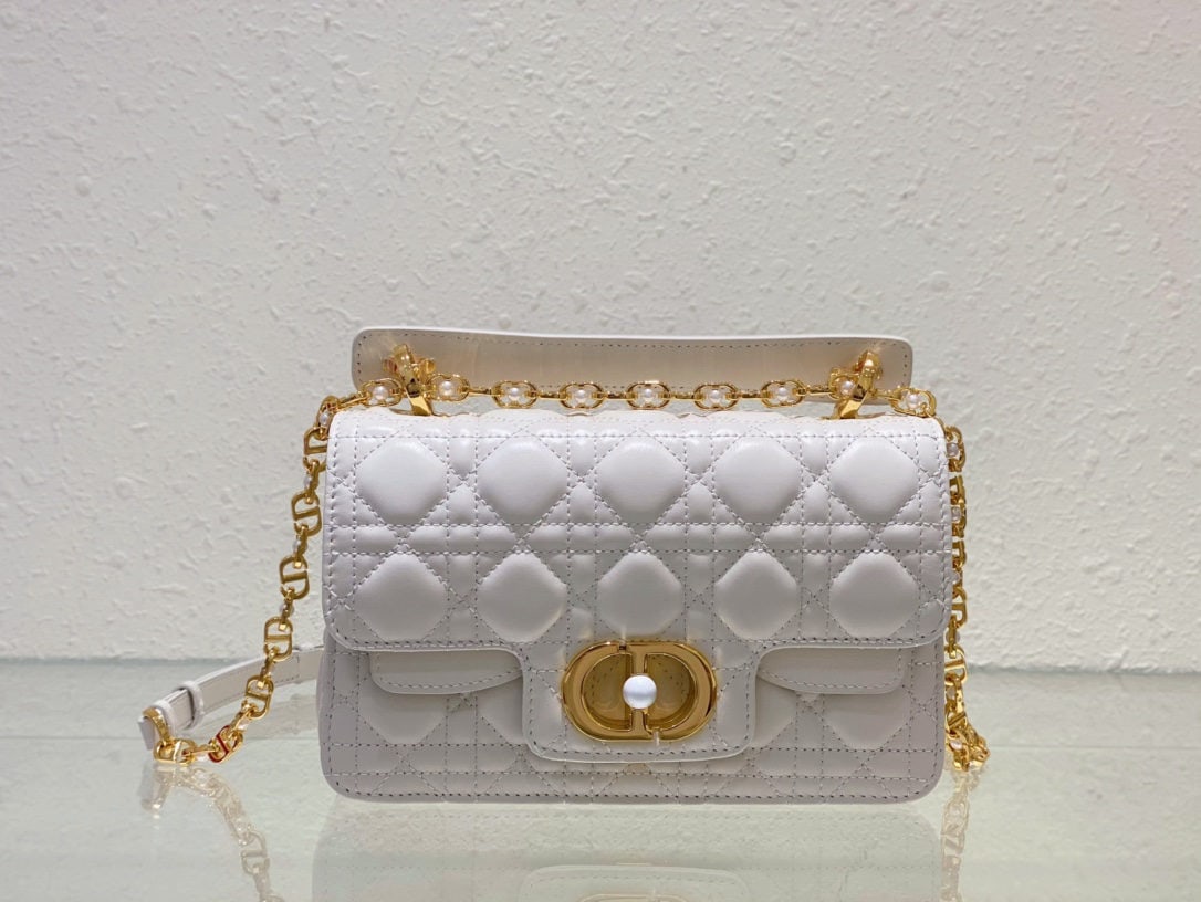 Christian Dior Jolie: This Dior Jolie handbag, crafted from white calfskin in a cannage pattern, is part of the Spring/Summer 2024 ready to wear collection. It combines elegance with practicality. Made from white calfskin