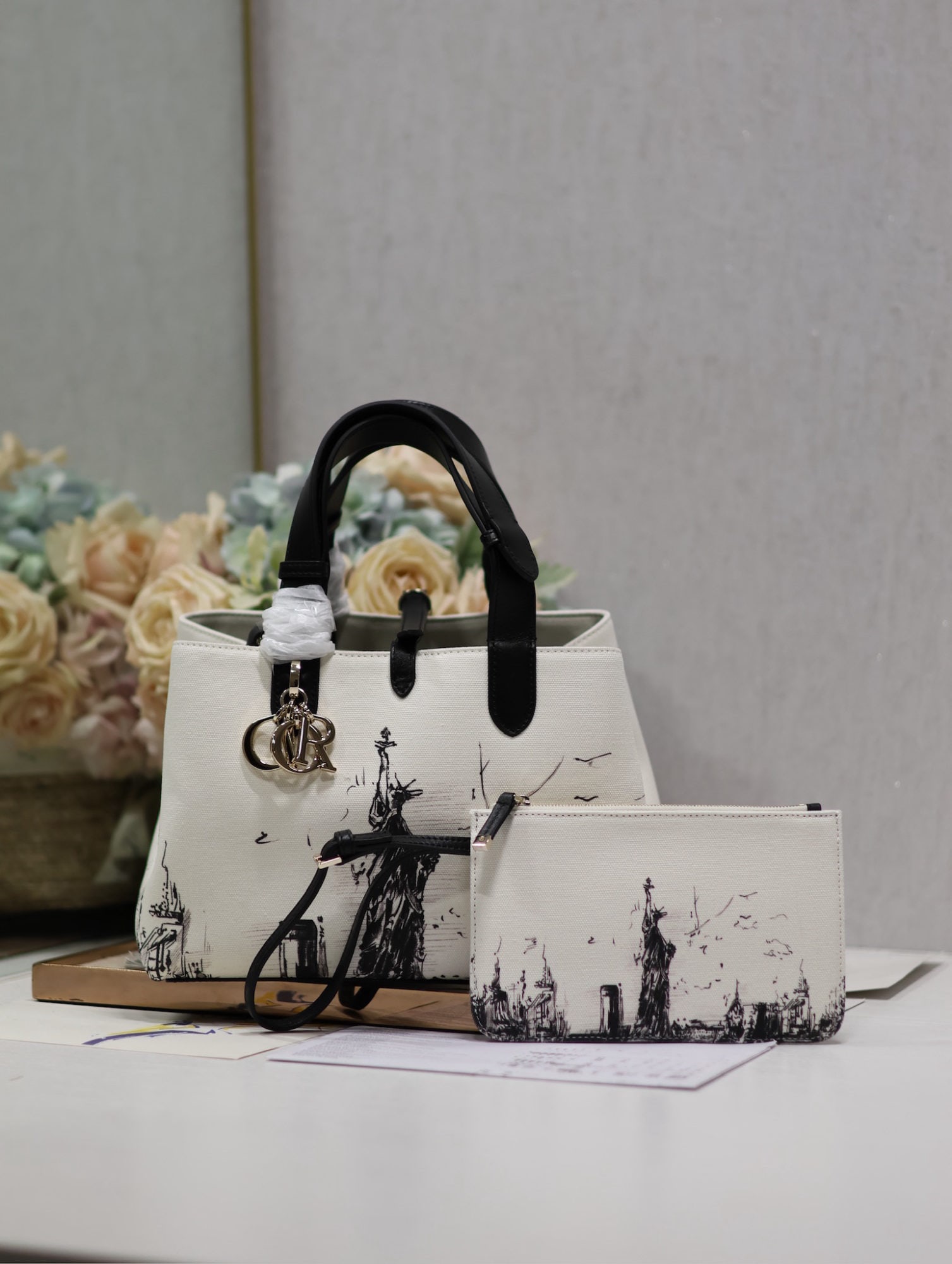 Christian Dior TOUJOURS: Dior Toujours Statue of Liberty Handbag (Medium, Canvas and Leather) The Dior Toujours handbag made a stunning debut in the Spring/Summer 2024 collection, showcasing a unique blend of casual and pract