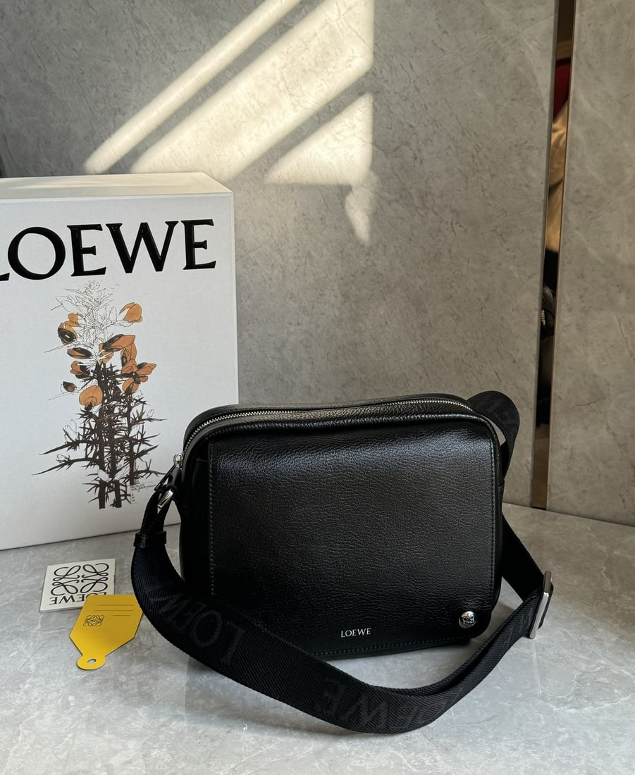 LOEWE: The LOEWE Pebble messenger bag is crafted from supple grained cowhide leather and features an adjustable LOEWE webbing shoulder strap for enhanced comfort. A versatile accessory for everyday