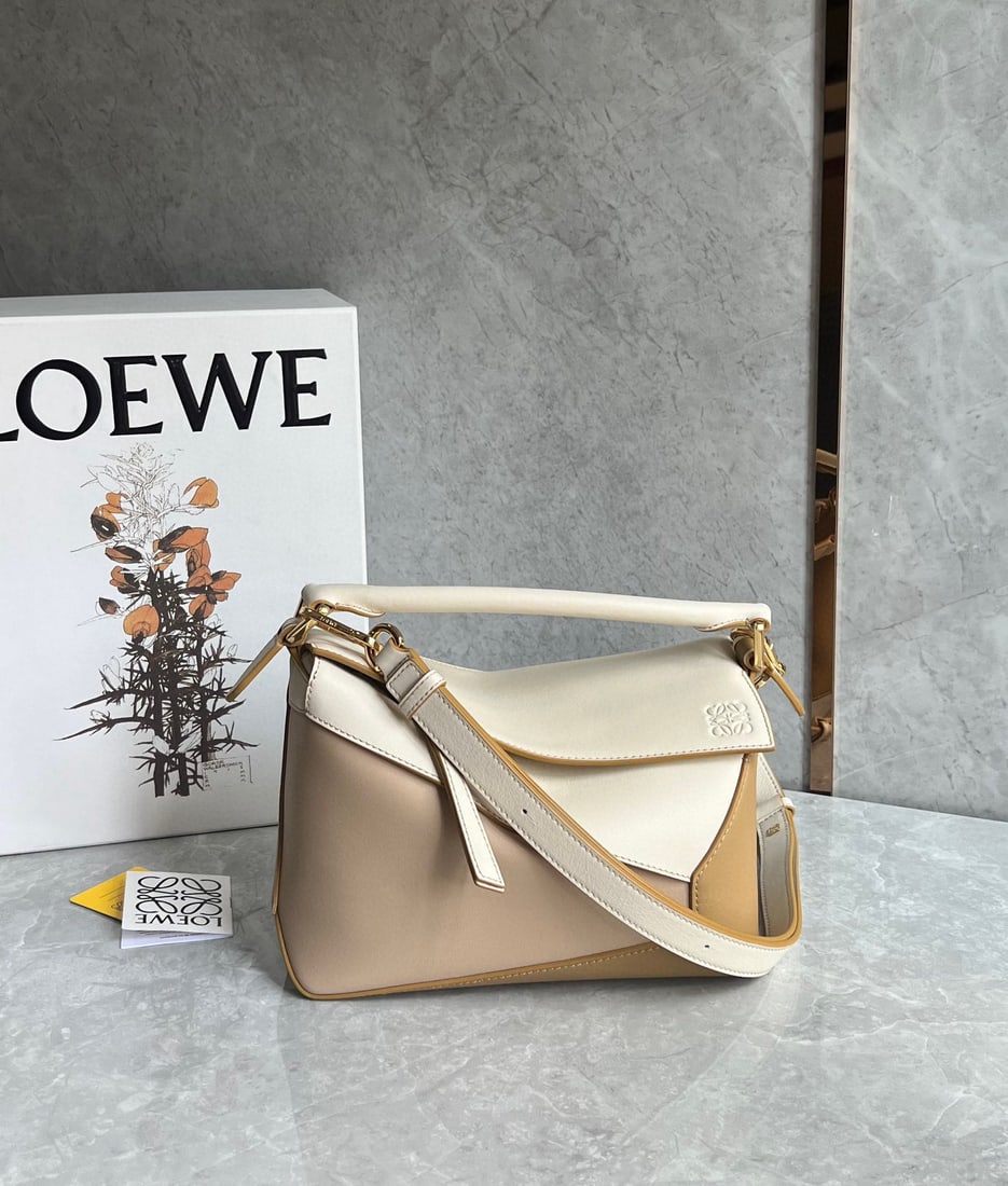 LOEWE: The LOEWE Puzzle bag is made of calfskin with a color blocked design. It's lightweight yet has a surprisingly large capacity, making it practical, versatile, and convenient for travel. The small size