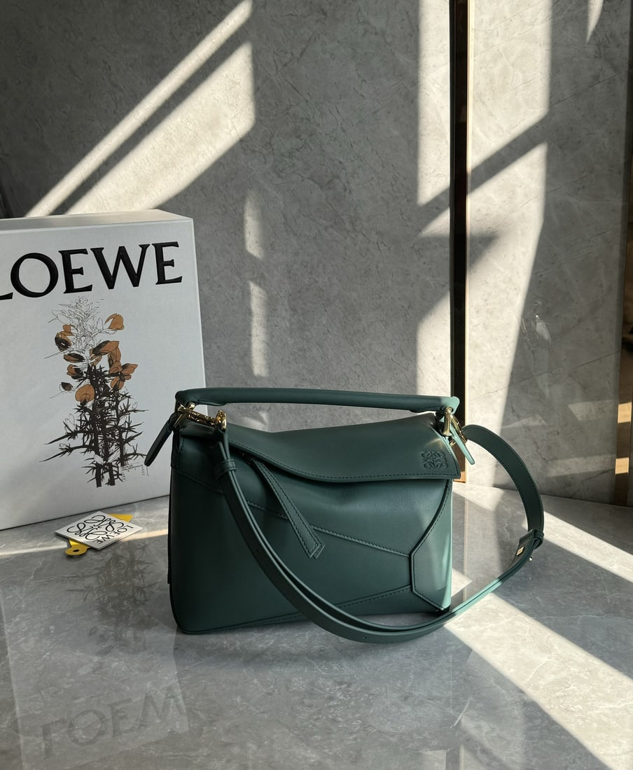 LOEWE: The LOEWE Vetiver Green Puzzle bag is made of calfskin. It's lightweight yet has a surprisingly large capacity, making it practical, versatile, and convenient for travel. Small size: 24 x 16 x 10 cm.
