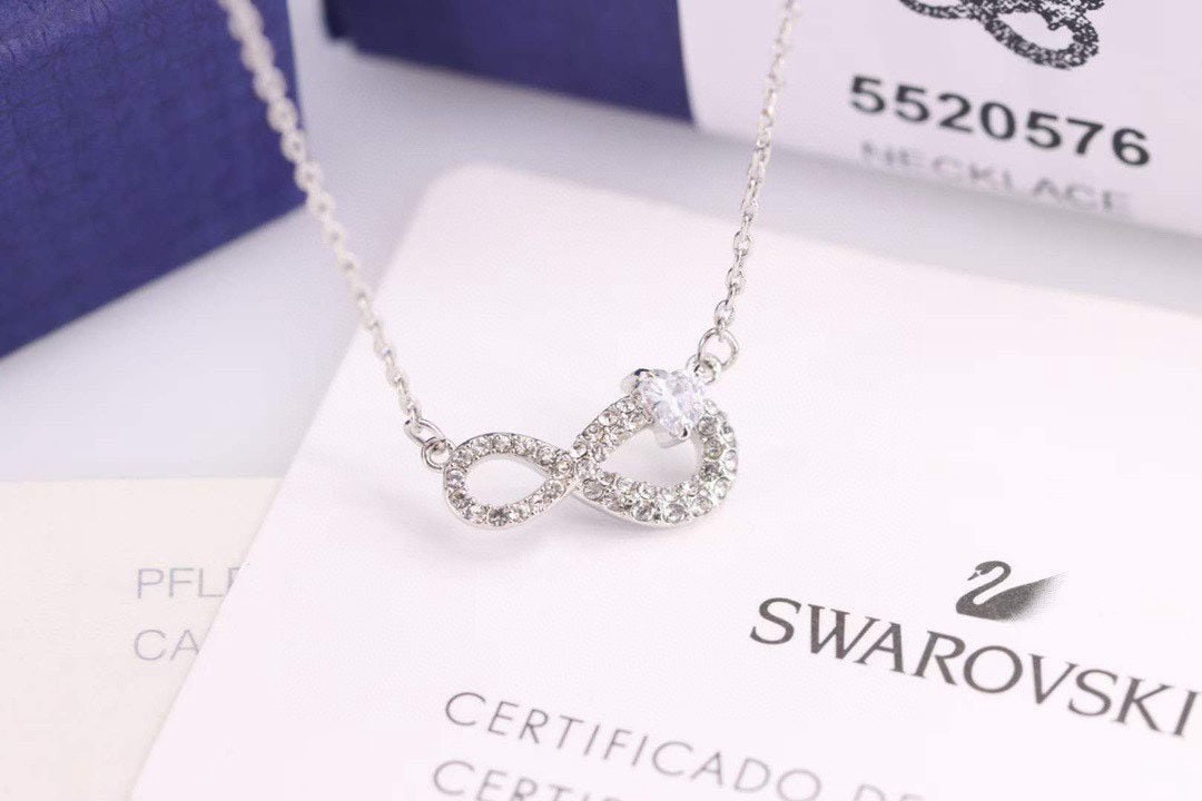 SWAROVSKI necklace: SWAROVSKI Endless Love Figure 8 Heart Shaped Necklace: This necklace, adorned with interwoven symbols of infinity and heart shapes, is embellished with a dazzling SWAROVSKI crystal, adding a striking 