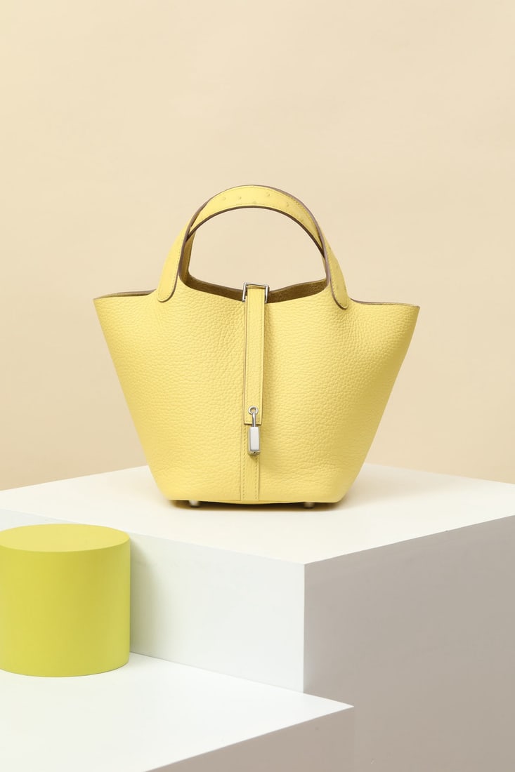 Hermes: Model: CL18 Code: CL180320 Color: 9R Lemon Yellow Dimensions: 18cm (L) x 13cm (D) x 18cm (W) Material: TC/Ostrich leather An additional strap and a dedicated "H" lock have been added to the opening