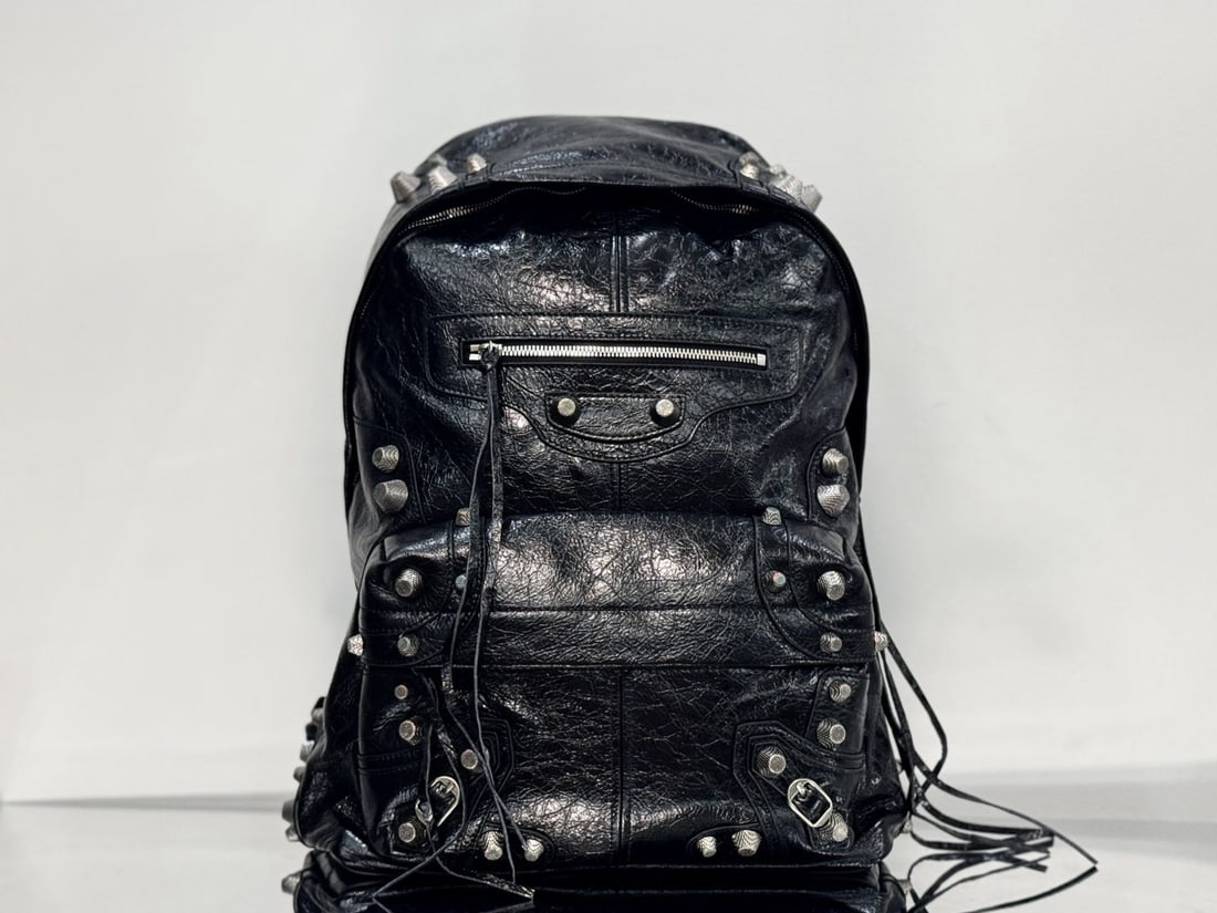 Balenciaga studded backpack: The Balenciaga Le Cagole studded backpack is made of Italian cracked lambskin, making it soft and comfortable. It retains the classic biker style while adding a touch of cool. The Balenciaga has a