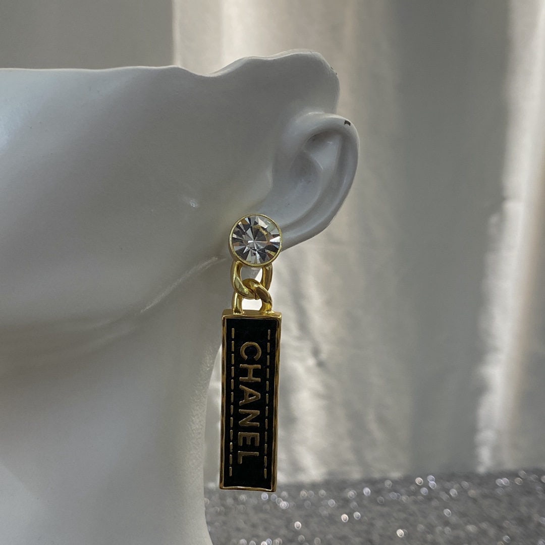 Chanel Black and Gold Leather Rhinestone Letter Stud Earrings: Chanel stud earrings, black and gold textured leather with rhinestone lettering, ultra retro vintage style, versatile, classic and elegant. We offer FREE SHIPPING for both domestic and international c