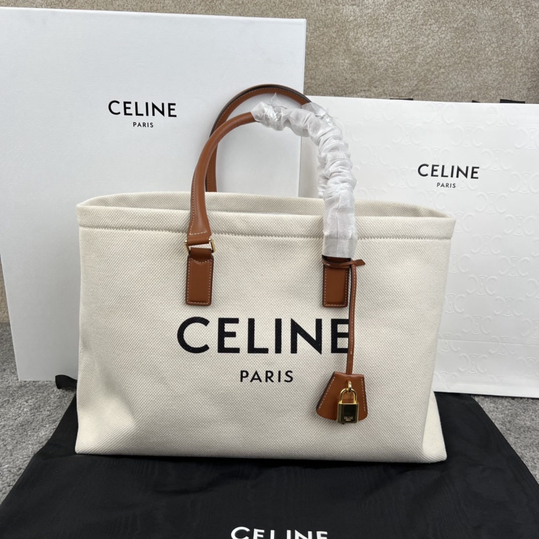 Celine: CABAS Horizontal Printed Canvas and Calfskin Handbag. CELINE's horizontal CABAS handbag features printed canvas and calfskin trim, leather handles, and a leather cover for the padlock. 17 x 13 x 6