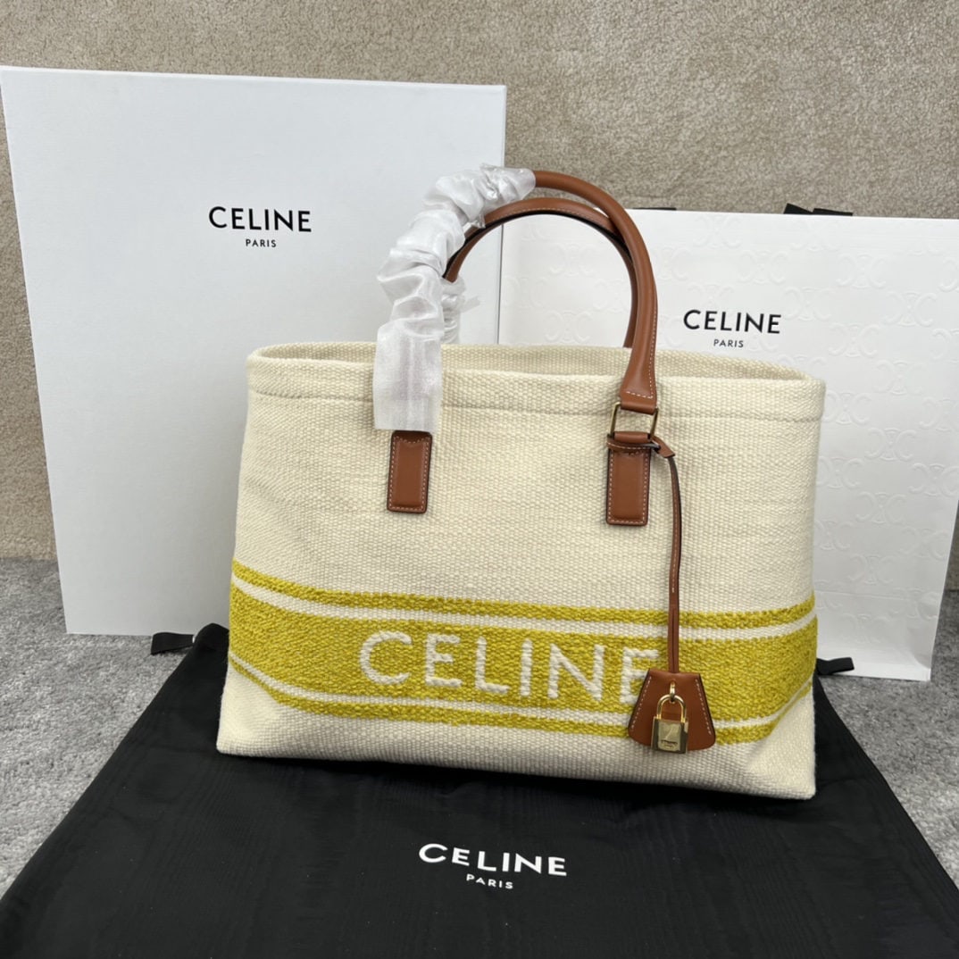Celine: CABAS Horizontal Printed Canvas and Calfskin Handbag. CELINE's horizontal CABAS handbag features printed canvas and calfskin trim, leather handles, and a leather cover for the padlock. 17 x 13 x 6