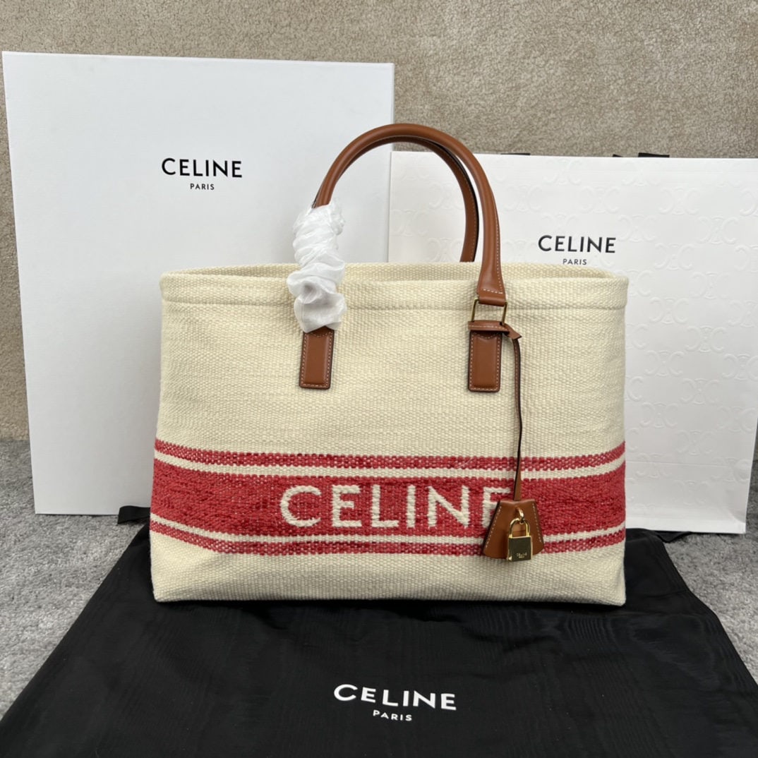 Celine: CABAS Horizontal Printed Canvas and Calfskin Handbag. This horizontal CABAS handbag features printed canvas and calfskin trim, leather handles, and a padlock with a leather cover. 17 x 13 x 6 inches