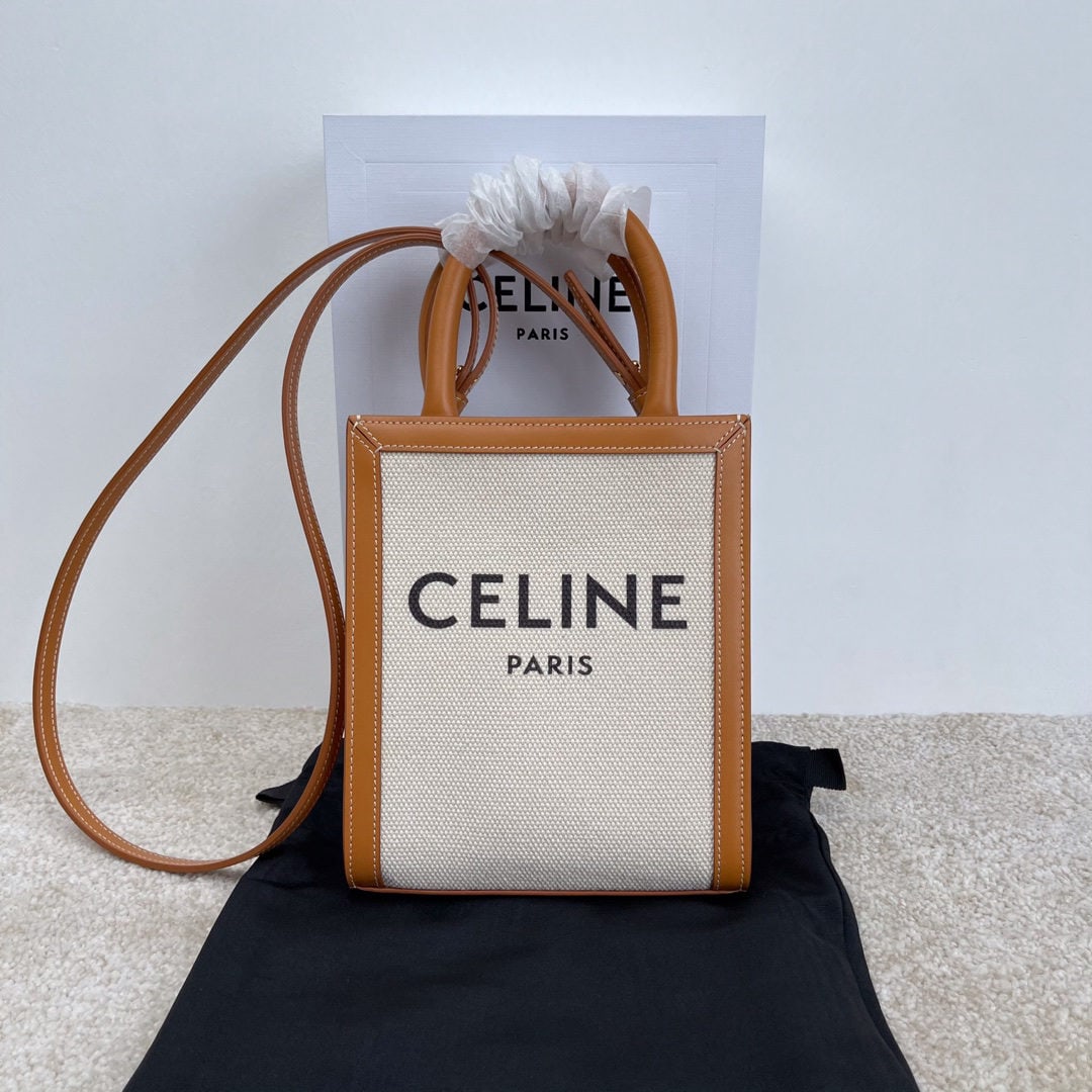 Celine: CABAS TRIOMPHE CANVAS logo print vertical mini handbag 7 x 8 x 2 inches (17 x 21 x 4 cm) faux leather lining; adjustable and detachable fabric leather shoulder strap 20 inches (50 cm) long. We offer F