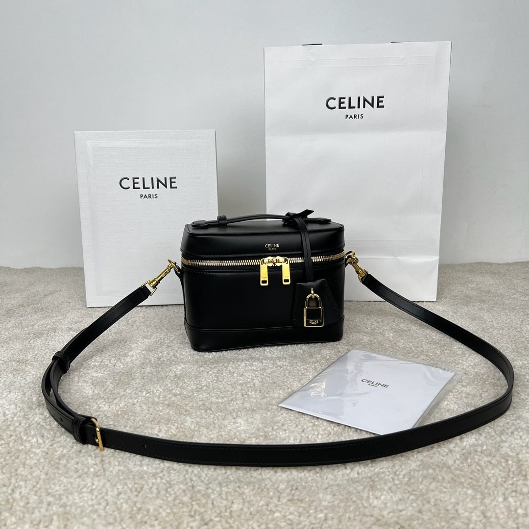 Celine: Cowhide leather vanity case, dimensions 18 x 12 x 18 cm, made of cowhide leather with a gold plated lining. Features handles, shoulder strap, and crossbody bag with double zip closures. Includes one
