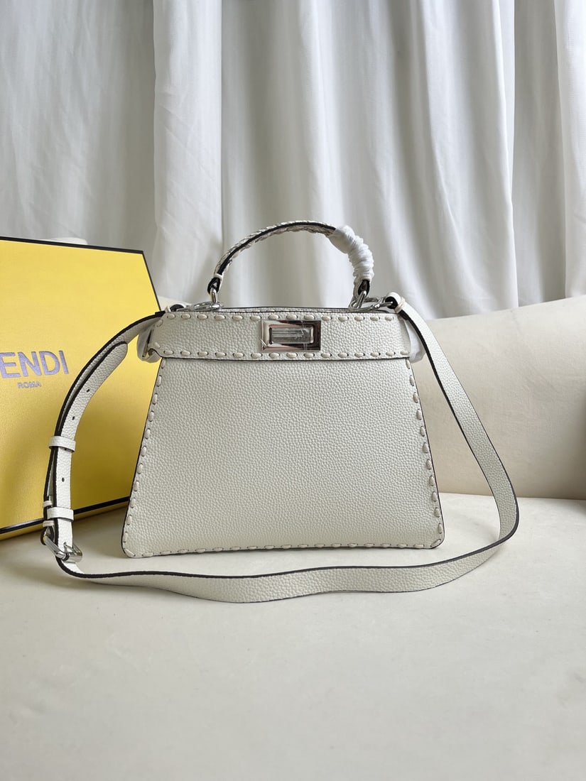 Fendi PeekabooISeeU: The FENDI Peekaboo I See U medium sized handbag is made of white python skin, crafted from pebbled calfskin. It features classic twist locks on both sides, a soft Nappa leather lining, two compartment