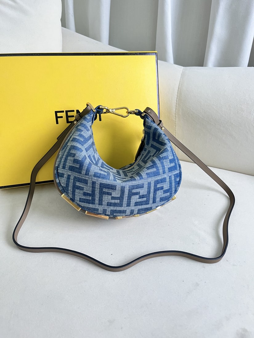 Fendi Praphy: This small denim Praphy underarm bag features a crescent shape and a classic large metal logo at the bottom. The bag's silhouette hugs the body's lines, creating a stylish look when worn under the arm
