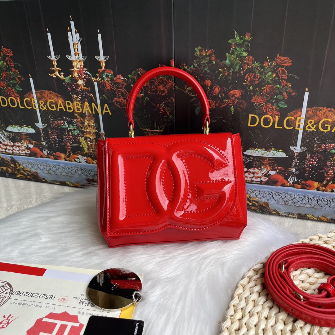 Dolce & Gabbana: Dolce & Gabbana's exquisite handcrafted leather bag features a calfskin body with hand painted edges for a structured look. The quilted DG logo adds a touch of modern style, making it a favorite among