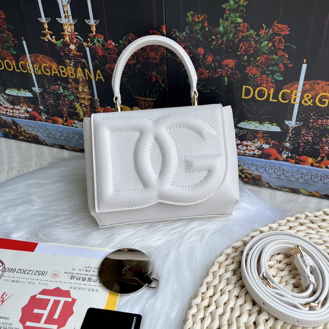 Dolce & Gabbana: Dolce & Gabbana's exquisite handcrafted leather bag features a calfskin body with hand painted edges for a structured look. The quilted DG logo adds a touch of modern style, making it a favorite among