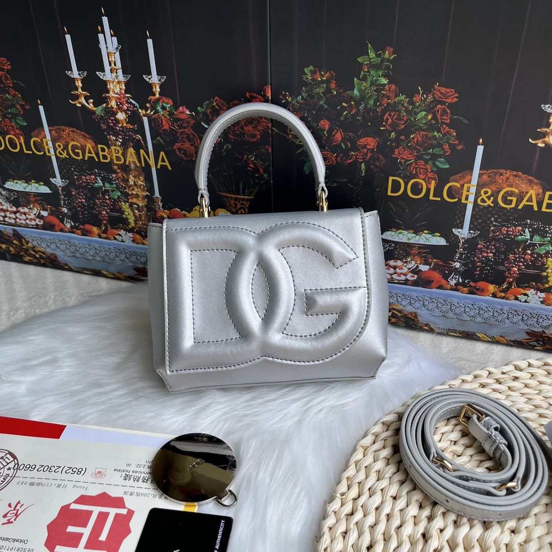 Dolce & Gabbana: Dolce & Gabbana's exquisite handcrafted leather bag features a calfskin body with hand painted edges for a structured look. The quilted DG logo adds a touch of modern style, making it a favorite among