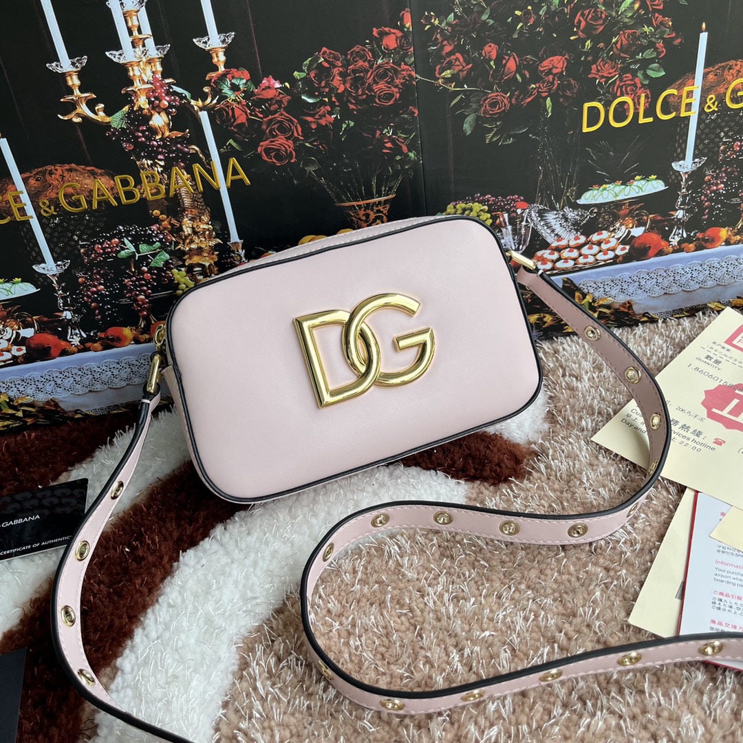 Dolce & Gabbana: Dolce & Gabbana crossbody bag. Exquisitely handcrafted from top grain cowhide leather. Features the DG logo on the front. The top edge is hand painted. A favorite of many celebrities, this stylish and
