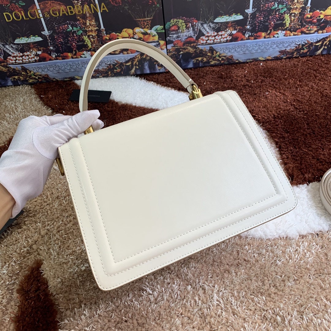 Dolce & Gabbana: Dolce & Gabbana's exquisitely handcrafted top grain cowhide leather bag features a hand painted edge. A favorite among many celebrities, this crossbody bag exudes style and sophistication, complementi