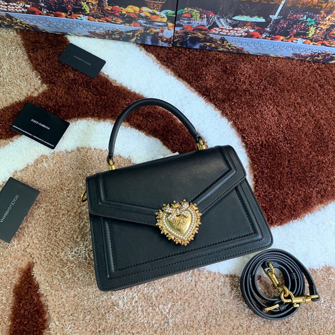 Dolce & Gabbana: Dolce & Gabbana's exquisitely handcrafted top grain cowhide leather bag features a hand painted edge. A favorite among many celebrities, this crossbody bag exudes style and sophistication, complementi