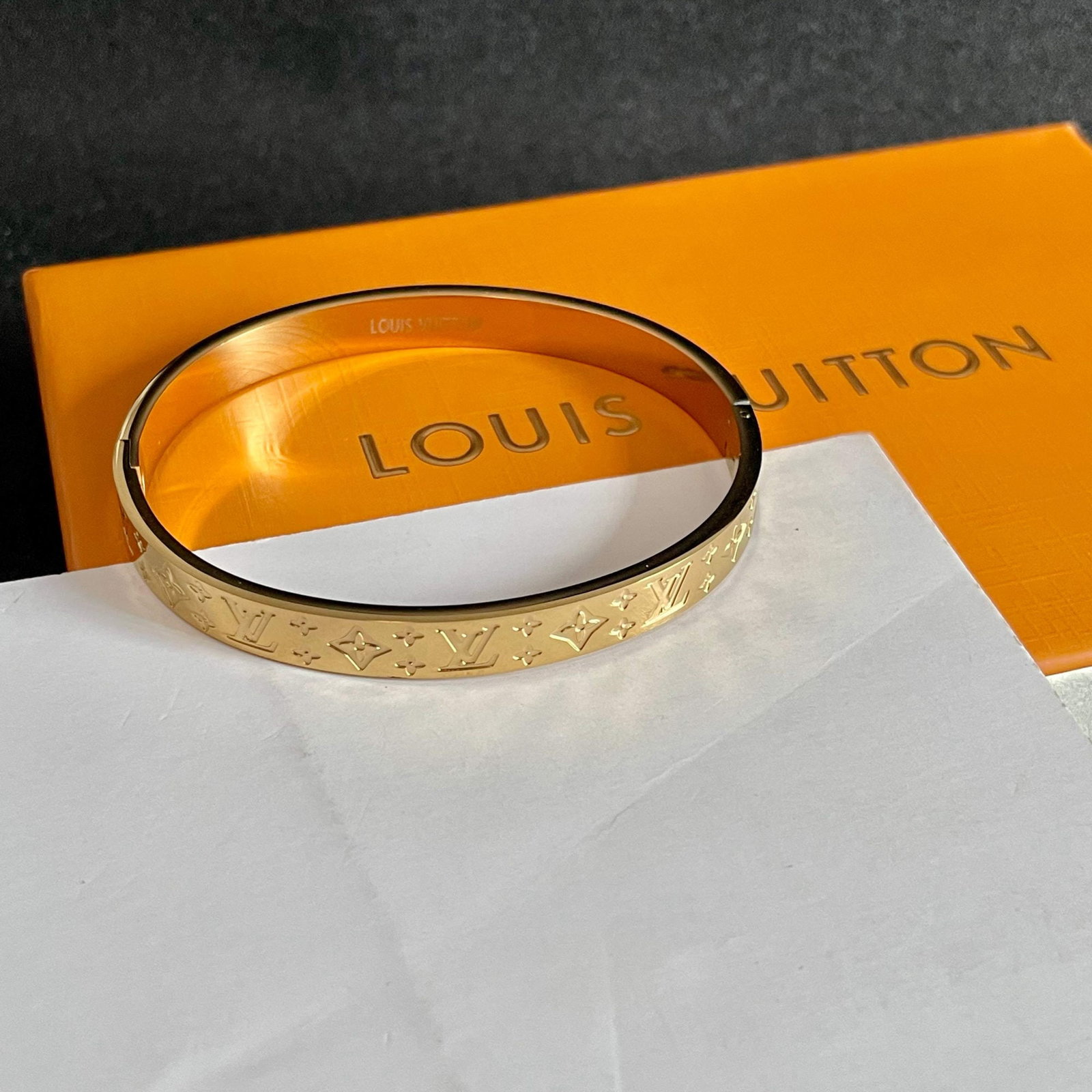 LV logo engraved narrow bracelet: This narrow LV logo bracelet features engraved lettering. Louis Vuitton's unique design, both retro and avant garde, has been a favorite among women since its launch. Each color boasts its own unique 