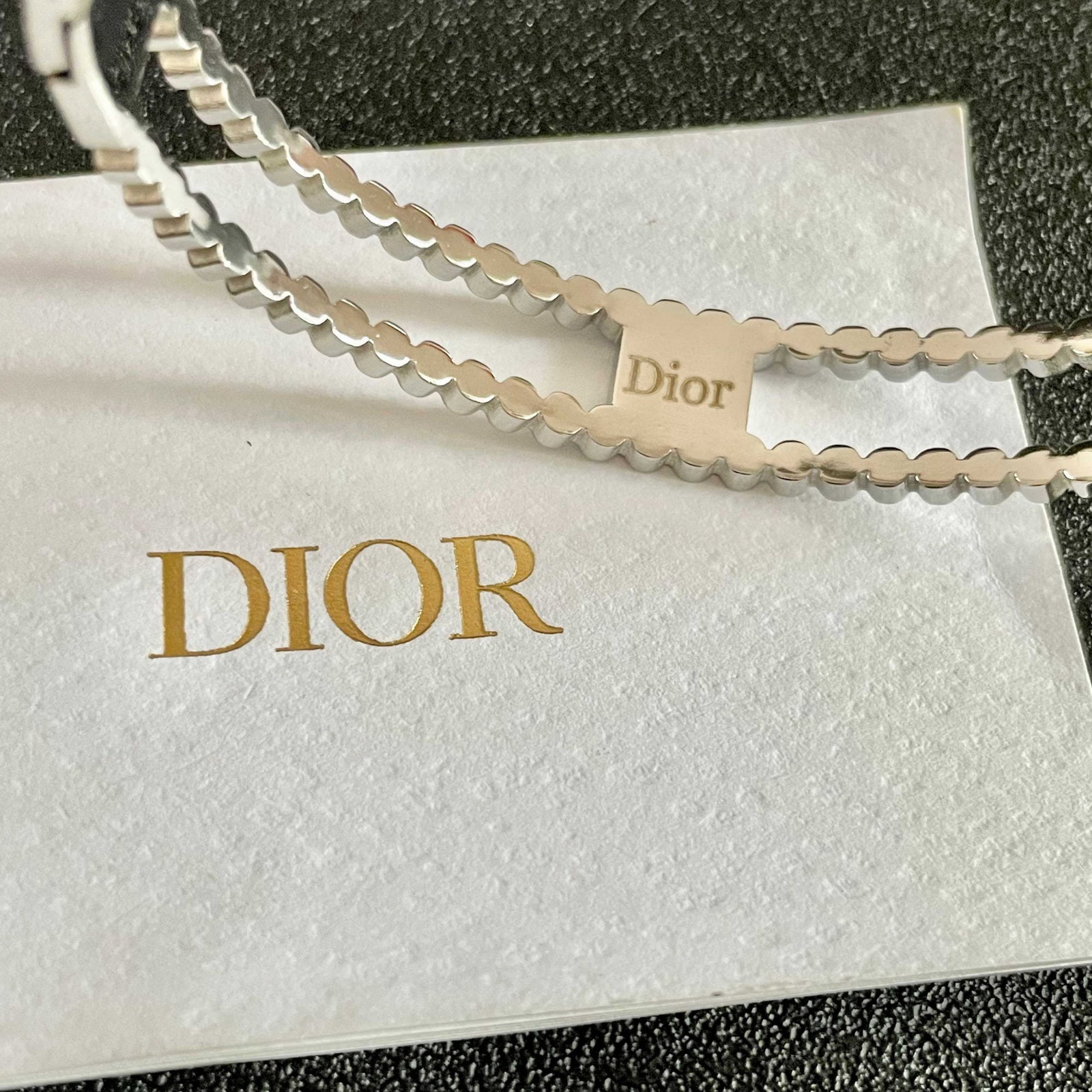 Dior's beautiful openwork diamond encrusted bracelet: Dior's beautiful openwork diamond encrusted bracelet is simple yet elegant, with a white gold color that is incredibly flattering and can be layered with other bracelets for a stunning look. We offer 