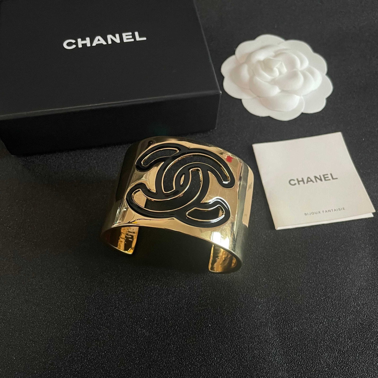 Chanel high quality wide bracelet: Chanel high quality wide bracelet with logo, black and white open design. A must have delicate accessory, suitable for all seasons! Elevates your style with subtle details, adding a touch of elegance 
